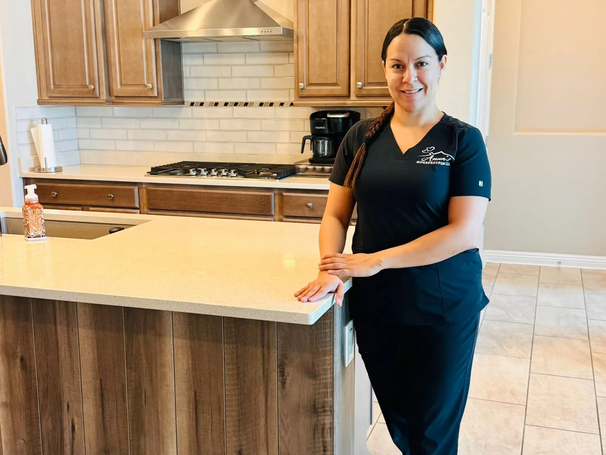 Anna's Housekeeping cleaner standing in a cleaned kitchen in a West Valley Arizona home